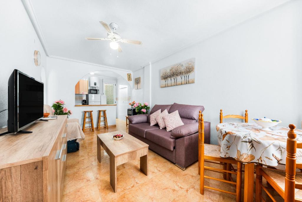 a living room with a couch and a table at Villa Patrick in Torrevieja