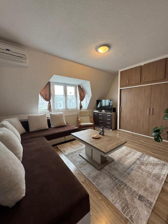 a living room with a couch and a coffee table at Magaslak in Balatonalmádi