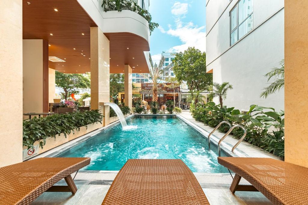 a swimming pool in the middle of a building at My Khe Hotel in Danang