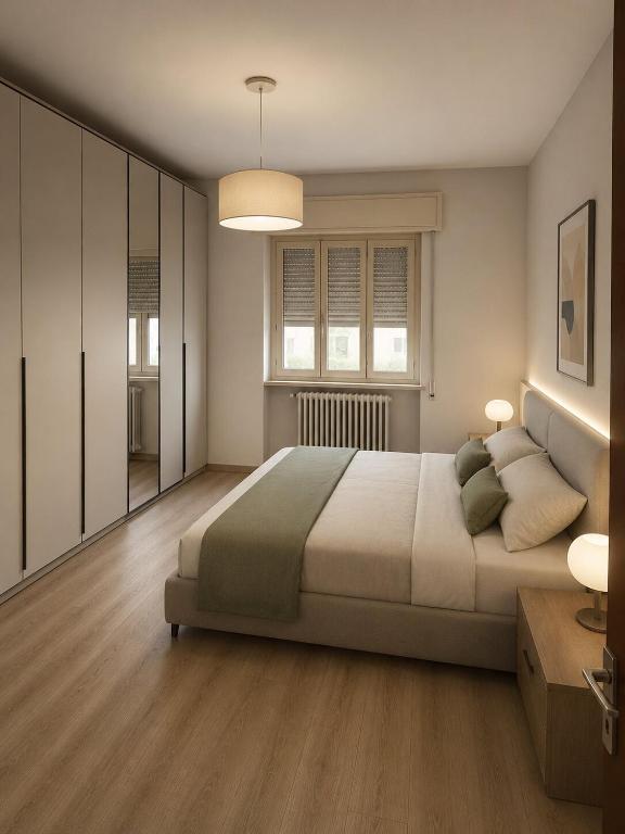 a bedroom with a large bed and two windows at LatinaStreet Apartament in Riccione