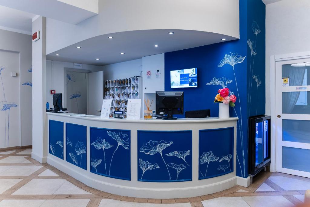 a blue room with a counter with flowers on the wall at Albergo Firenze in Florence