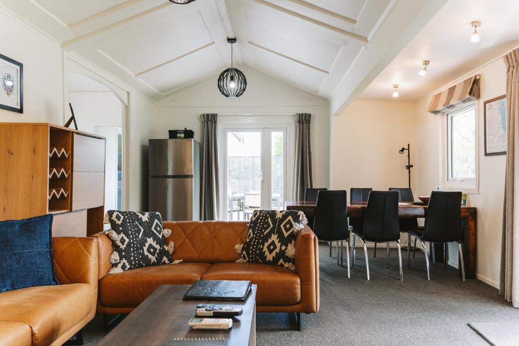 a living room with a couch and a table at Cottages On St Andrews in Havelock North