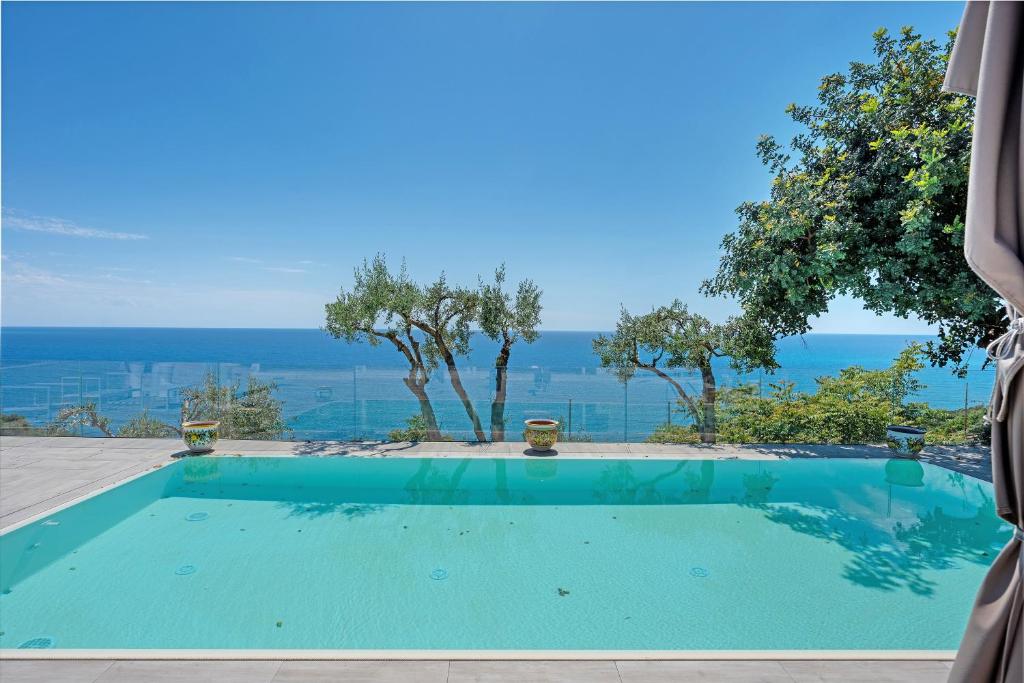 a swimming pool with a view of the ocean at Tenuta Donna Carmela in Pisciotta