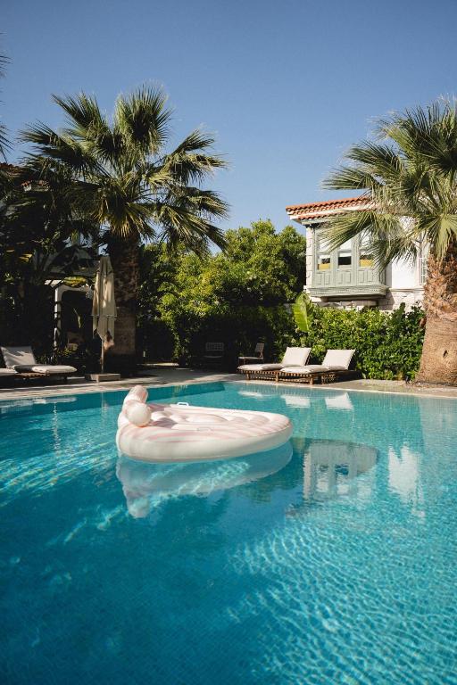 a swimming pool with a float in the water at Fiora Alacati in Alaçatı