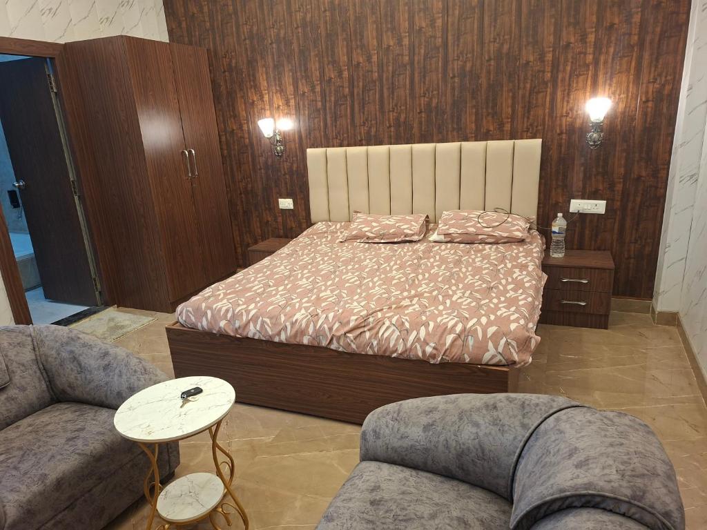 a bedroom with a bed and two couches at Prem niwas in Kakarmatha