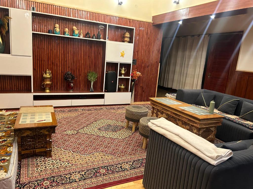 a living room with a couch and a table at Cho Farm House in Leh