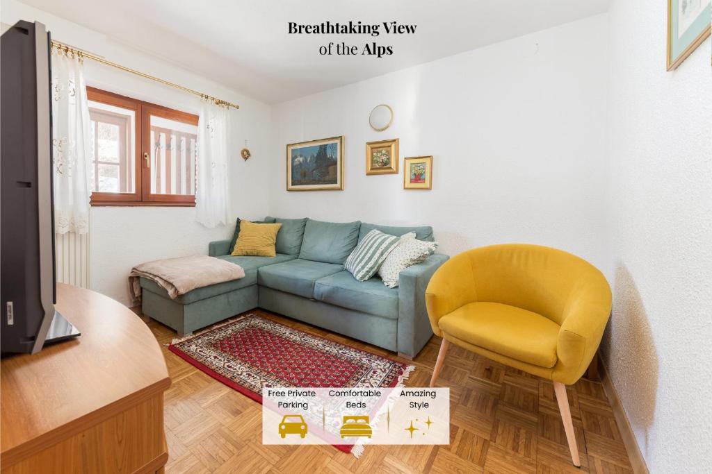 a living room with a blue couch and a yellow chair at Hiša nasproti sonca in Kranjska Gora