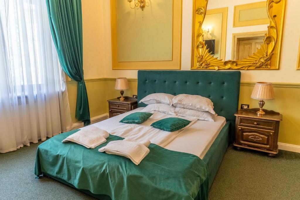 a bedroom with a large bed with towels on it at Hotel Boutique Casa Vermont in Bucharest