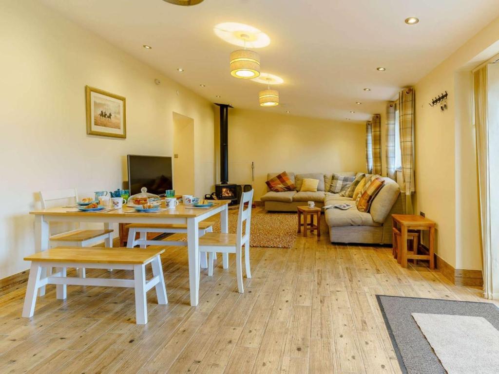 a living room with a table and chairs and a couch at 3 Bed in Usk- oc-87286 in Llandenny