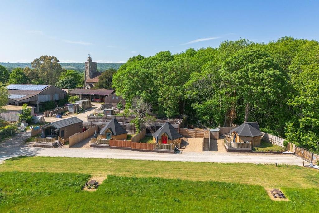 an aerial view of a park with houses and trees at Woods Meadow Glamping in West Malling