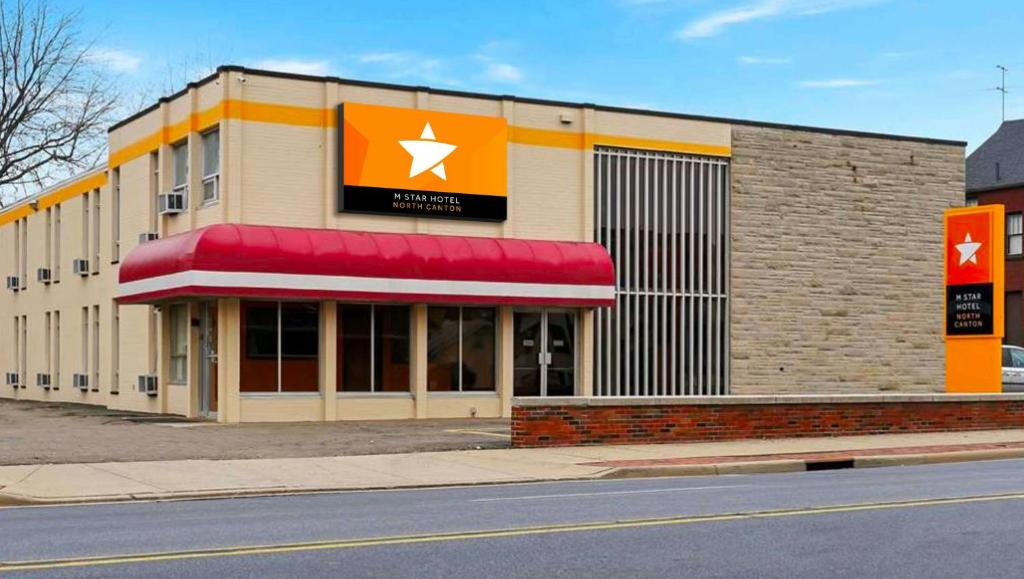 a building with a store on the side of a street at M Star North Canton - Hall of Fame in North Canton