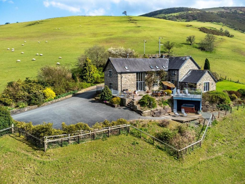 an aerial view of a house in a field at 5 Bed in Llangammarch Wells oc-bn162 in Garth