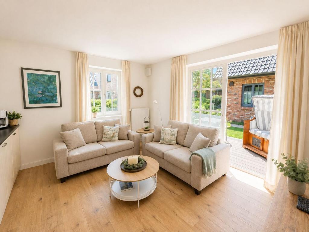 a living room with two couches and a table at Kormoran in List