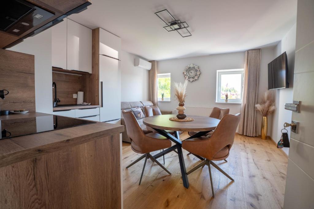 a kitchen and dining room with a table and chairs at Apartma na Grad in Ptuj