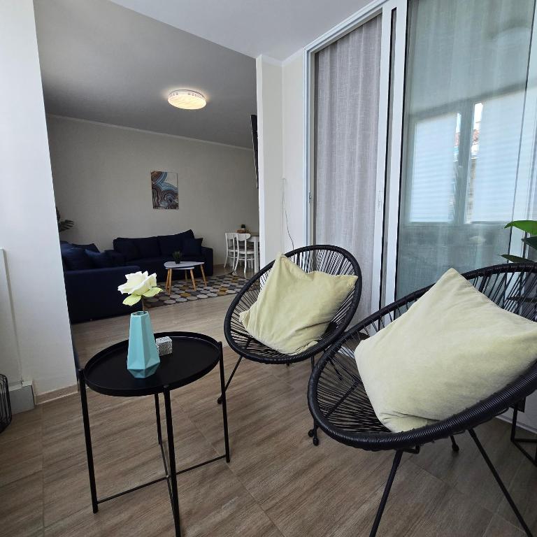 a living room with chairs and a table with a couch at Landmark 1BDR Apartment in Center, next to Metro in Sofia