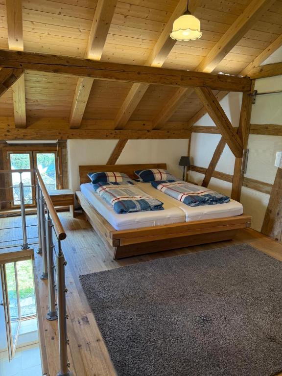 a bedroom with a bed in a room with wooden ceilings at Apostel Haus in Solnhofen