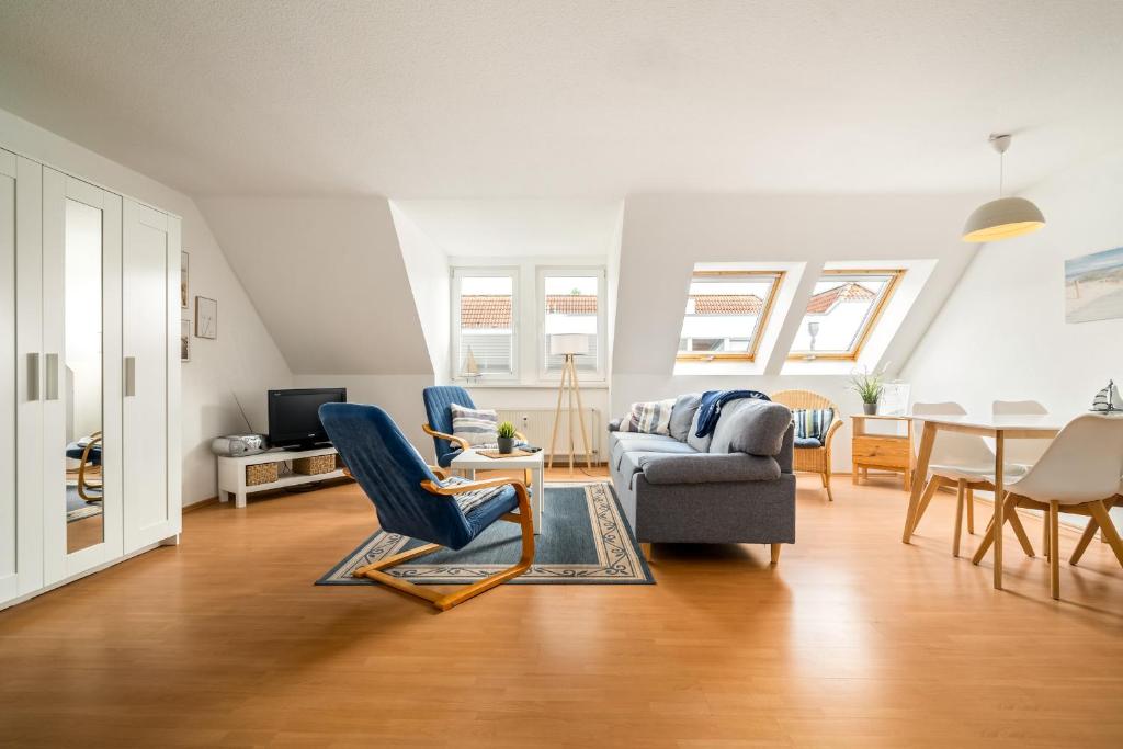 a living room with a couch and a chair at Studio - Modernes Design nahe Müritzstrand & Wellness in Waren