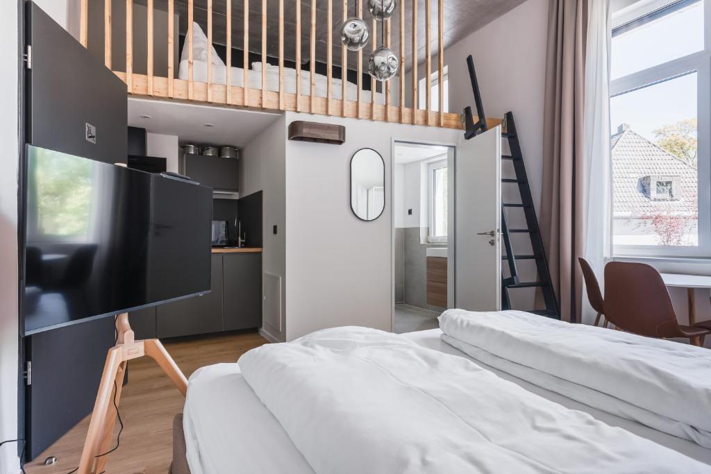 a bedroom with a bunk bed and a staircase at Villa Weitmar - Apartments und Private Spa in Bochum