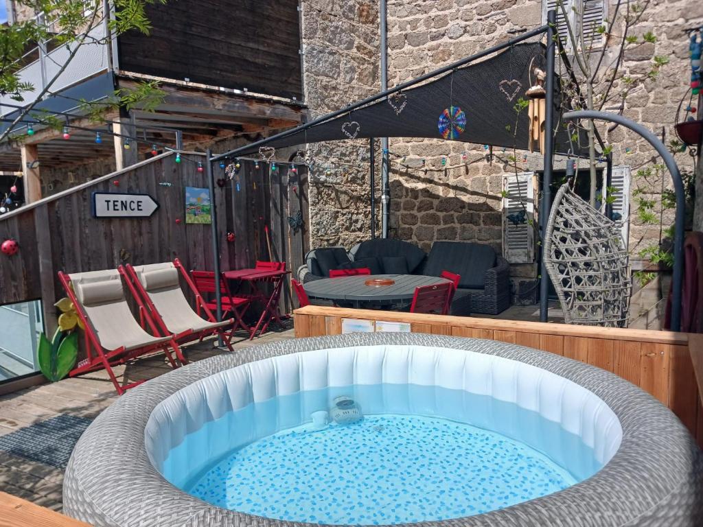 a hot tub in the middle of a patio at La Belle Tençoise in Tence