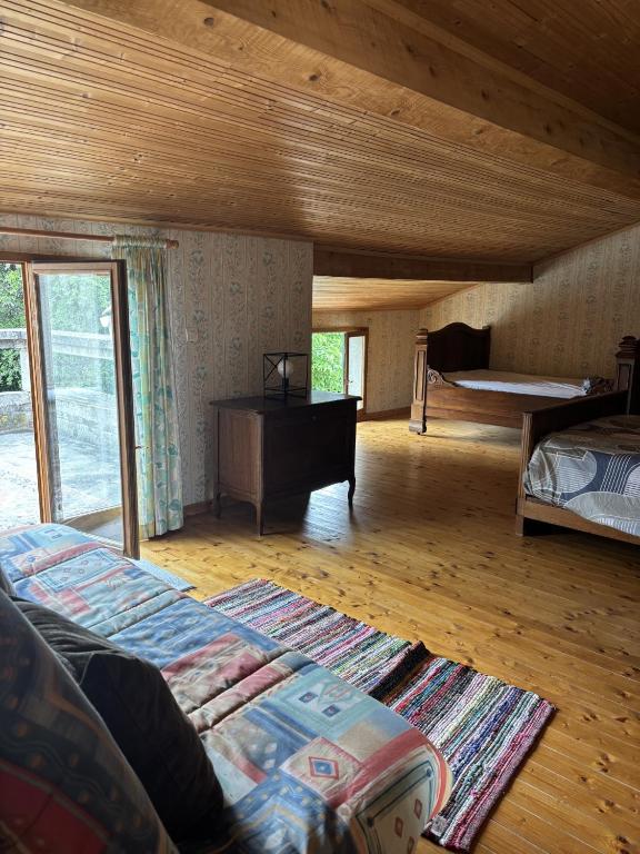 a large room with a bed and a piano at La Digeonne in Chabeuil