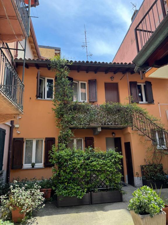 an orange building with plants on the side of it at Artdeco in Lecco