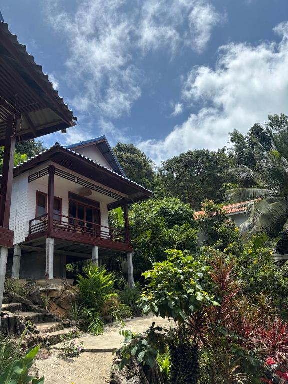 a house with a balcony on the side of it at Amber Koh Rong in Koh Rong Island
