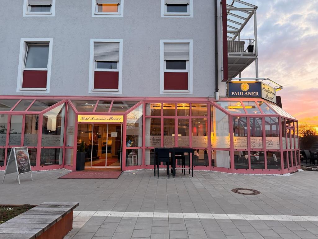a building with a piano in front of it at Hotel Mozart in Traunreut