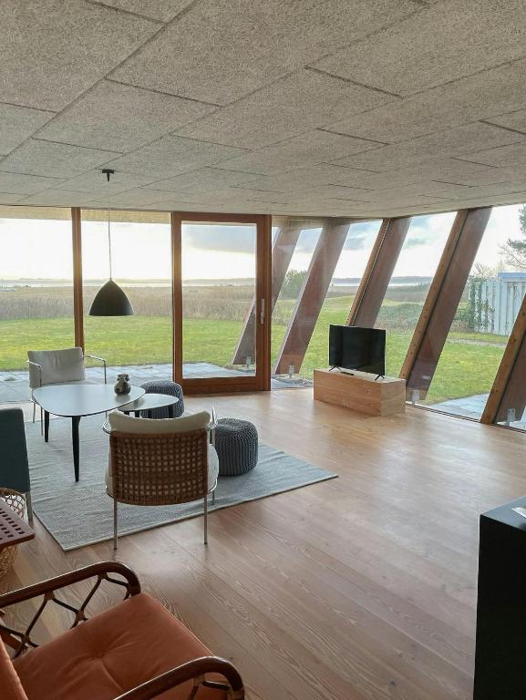 a living room with a table and a tv at View Over Aarhus Bay From Striking Architecture in Egå