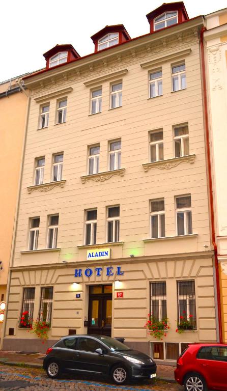 a black car parked in front of a hotel at Aladin Praha in Prague