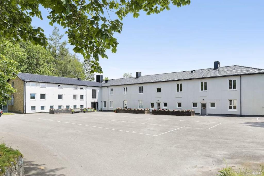 a large white building with a parking lot at Alkoven Logi in Ullared