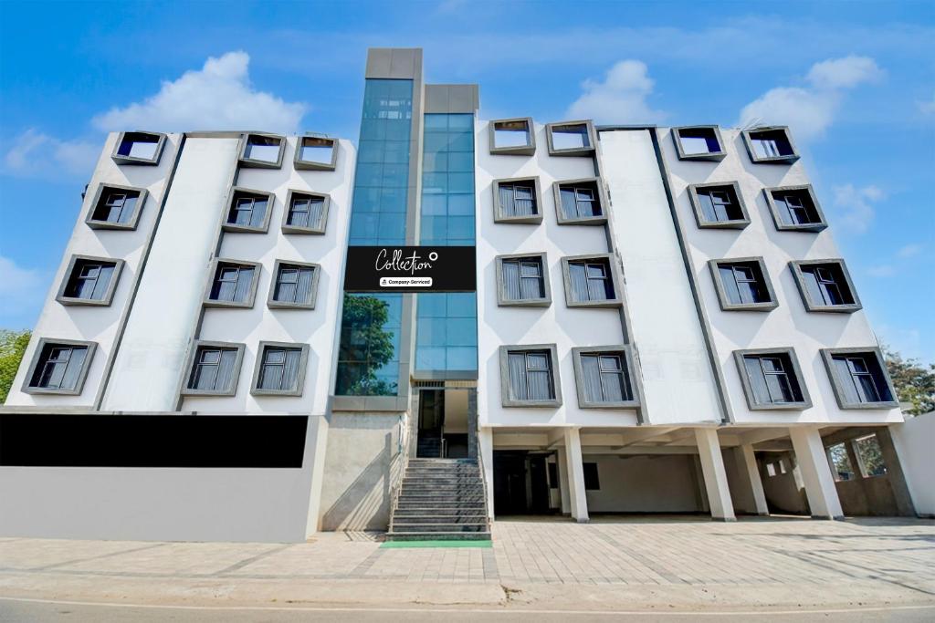 a large white building with a sign on it at Super Collection O MIDC Pimpari Pune Formerly SK Palace in Chinchwad