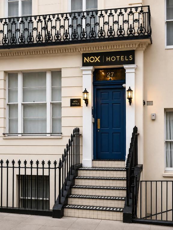 a blue door on the front of a building at NOX Paddington in London