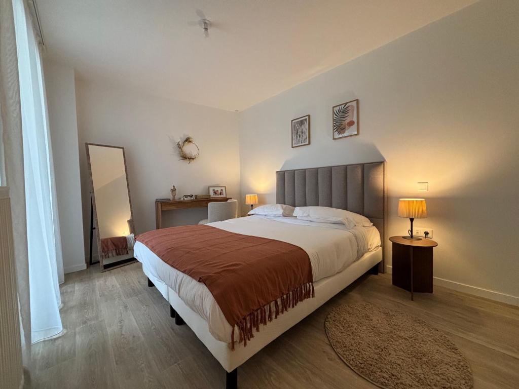 a bedroom with a large bed in a room at DOMITYS - Villa Caron - AEROPORT ORLY in Athis-Mons