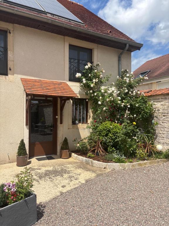 a house with a porch and flowers in front of it at Maison d’izier in Izier