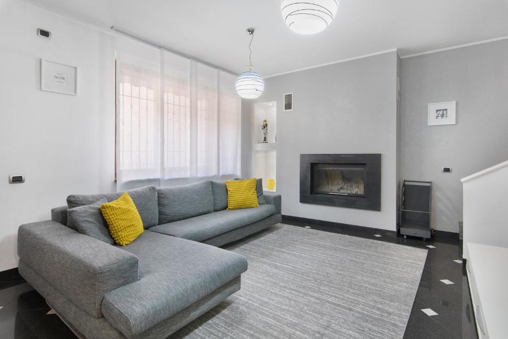 a living room with a couch and a fireplace at Villa In Saronno in Saronno