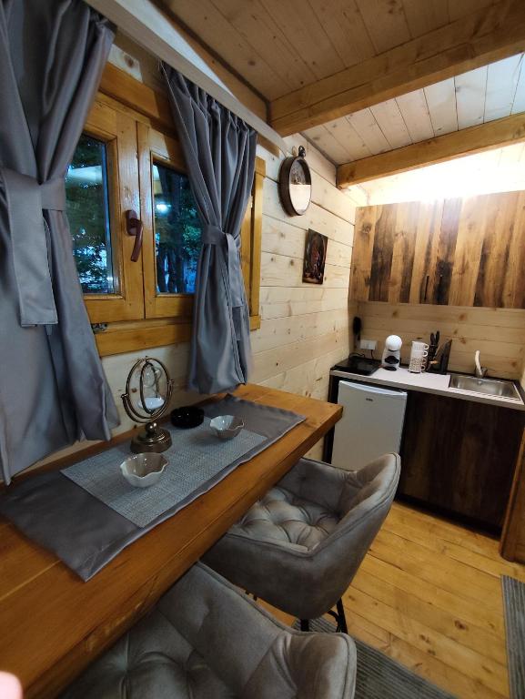 a dining room with a table and chairs in a kitchen at Brvnara Nido in Cetinje