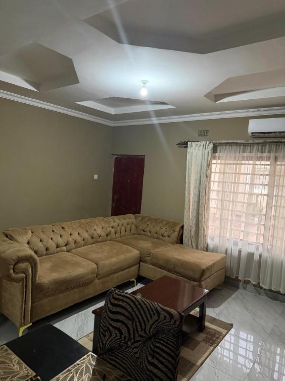 a living room with a couch and a table at Edmut Apartments in Lusaka