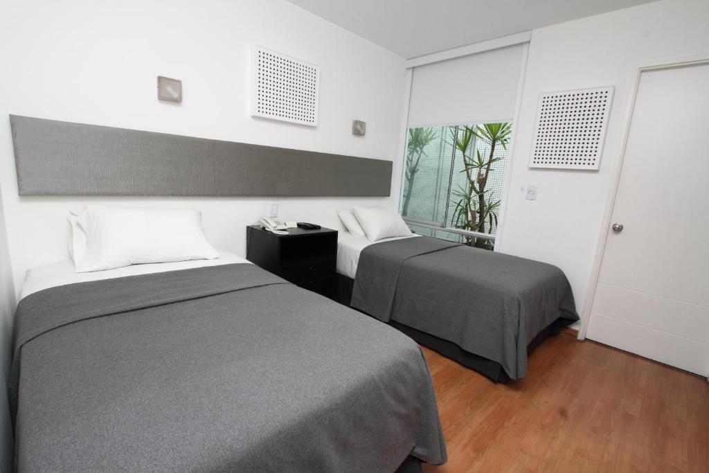 A bed or beds in a room at 3B Barranco's - Chic and Basic - B&B