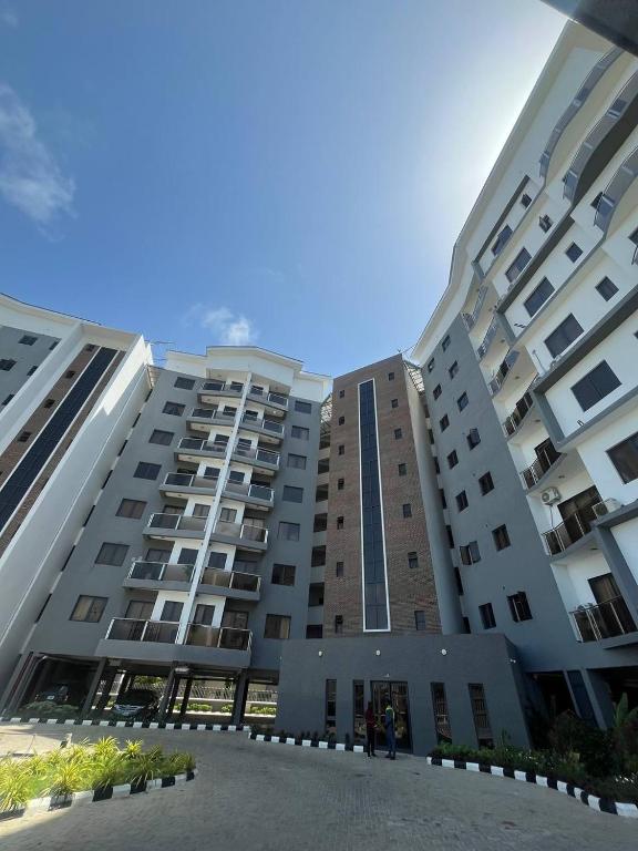 a large building with people standing in front of it at D'Empire in Lekki