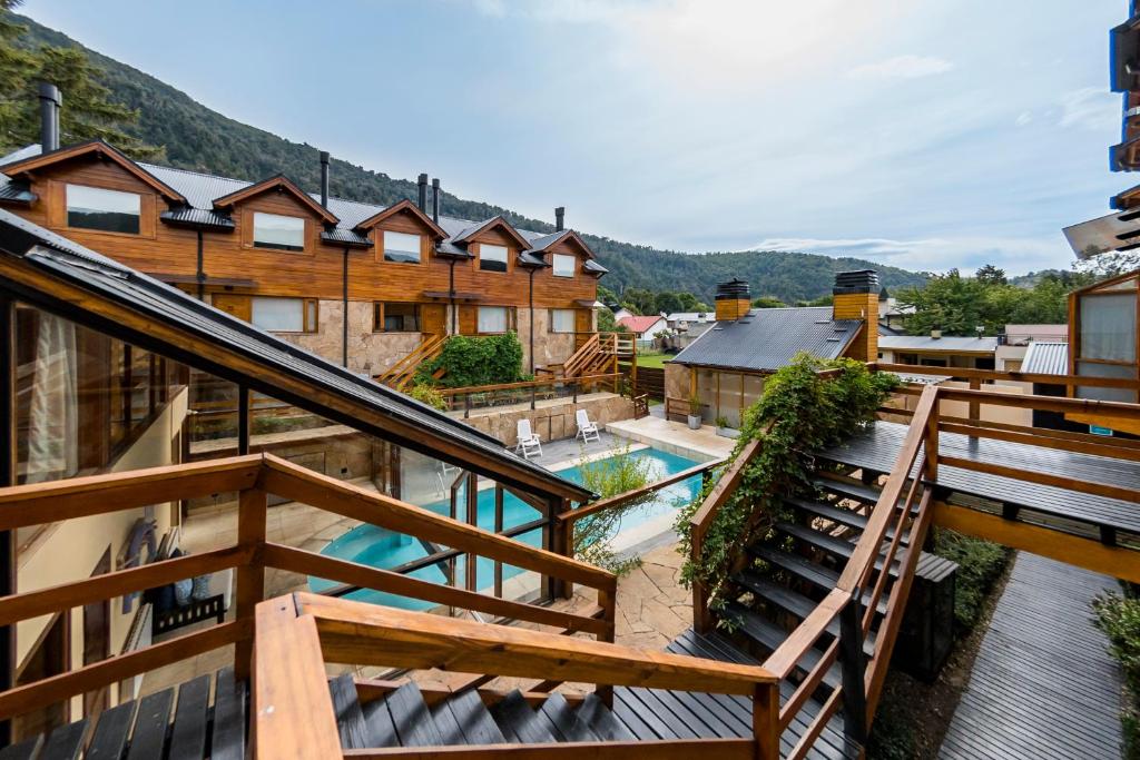 a balcony with a view of a pool and some buildings at Del Sauco Apart & Spa in San Martín de los Andes