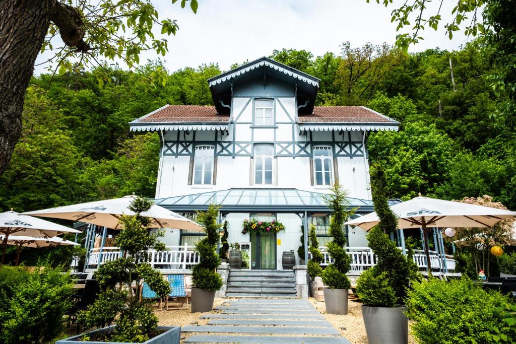 a white house with a stairway in front of it at Hotel La Tonnellerie in Spa