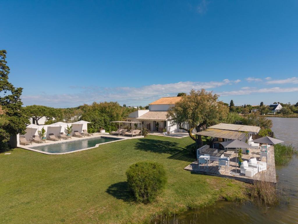 an aerial view of a house next to a body of water at Mas des Cabidoules in Saintes-Maries-de-la-Mer