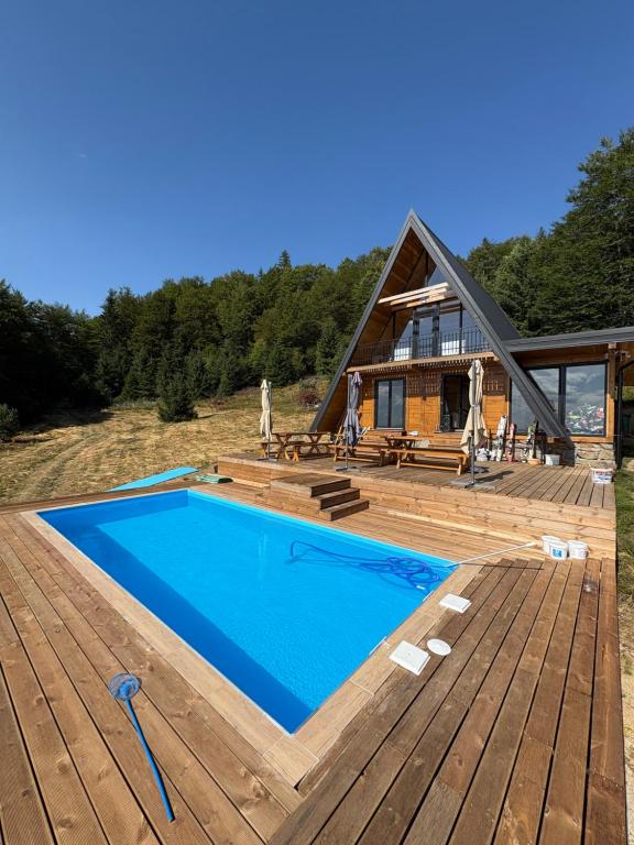 a house with a swimming pool on a wooden deck at Gorska vila Vasilija in Ivanjica