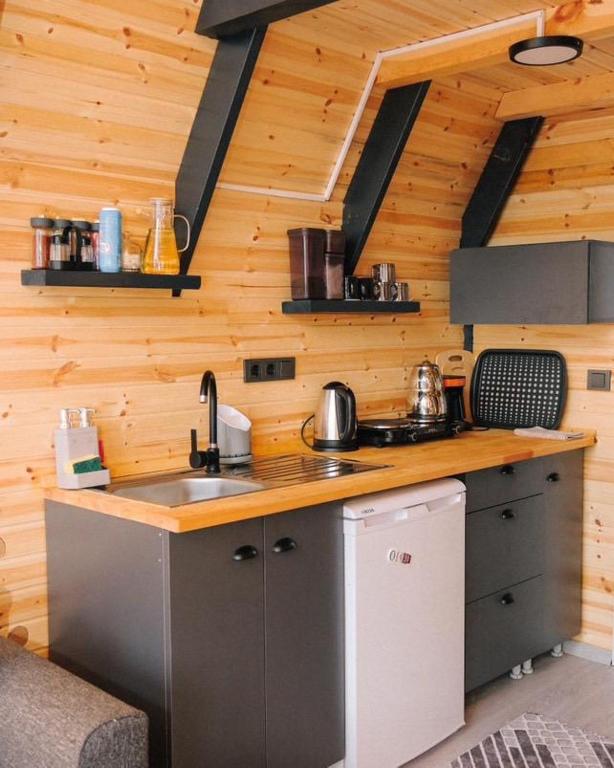 a kitchen in a wooden cabin with a sink at Altınkum Bungalov in Dereköy