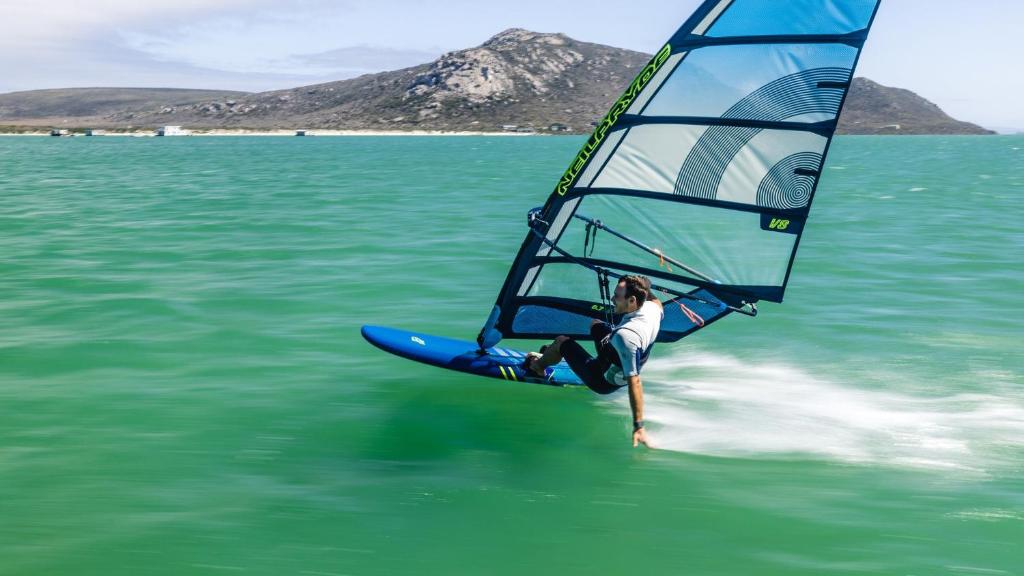 a man riding a wind sail on the water at Bellmullet, Waterside Townhouse in Belmullet