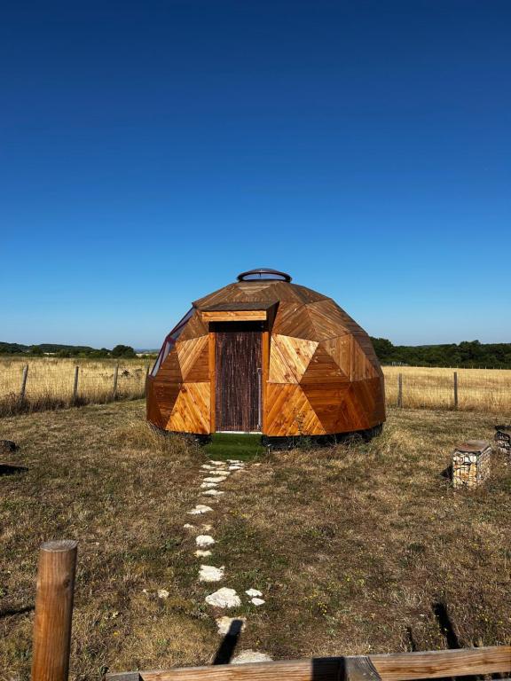 a large dome tent sitting in a field at Dôme géodésique in Brie