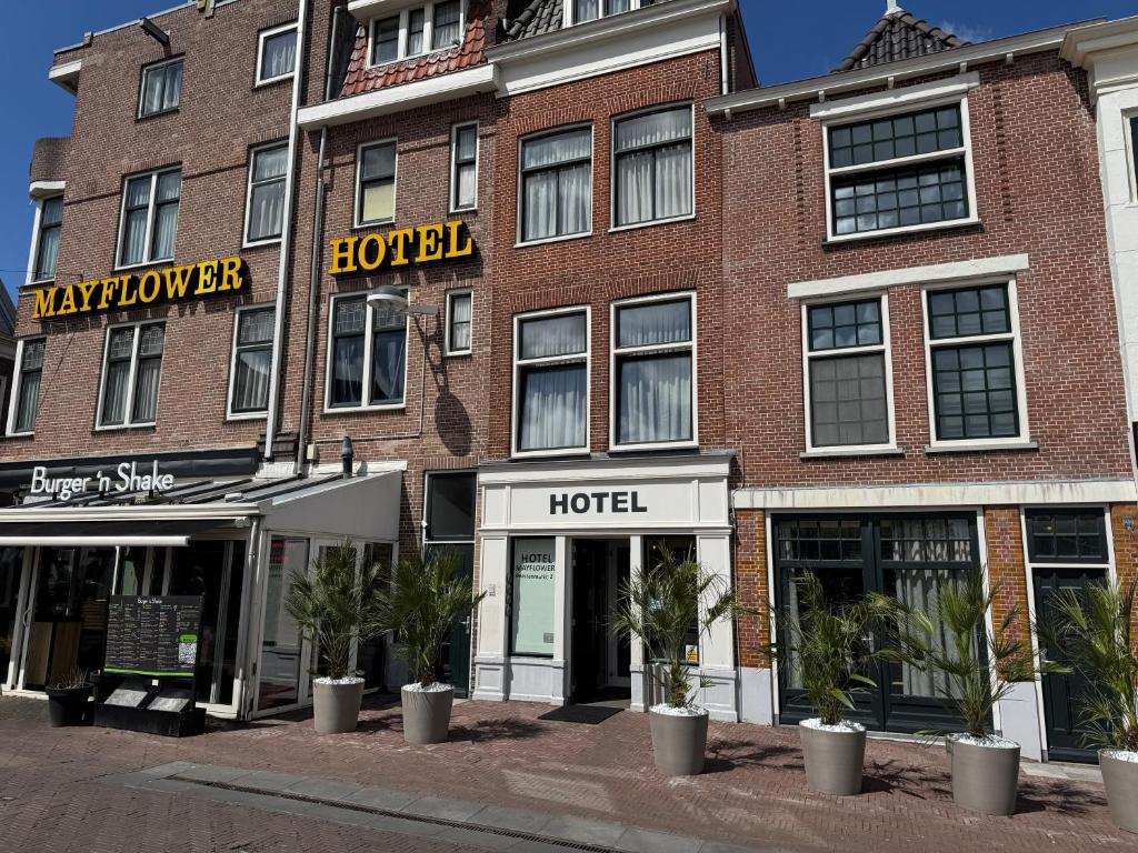 a large brick building with a hotel on a street at Hotel Mayflower in Leiden