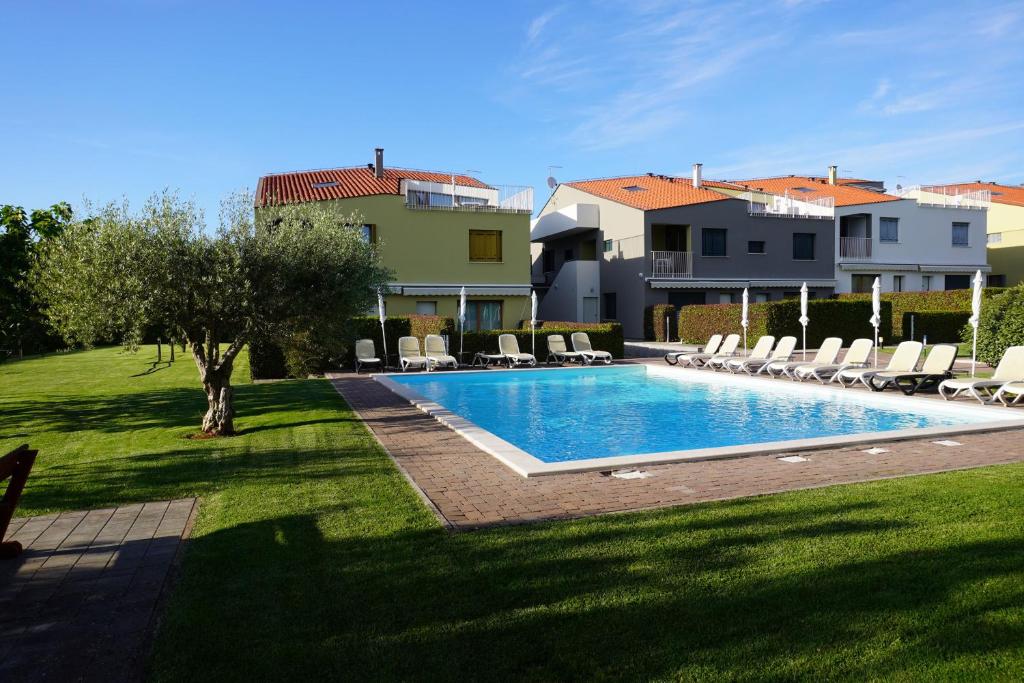 a swimming pool in a yard next to a house at Premium Apartment Maj **** in Poreč