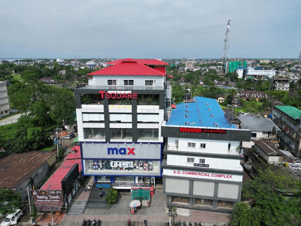 a building with a sign on the top of it at Hotel Subansiri in Dibrugarh