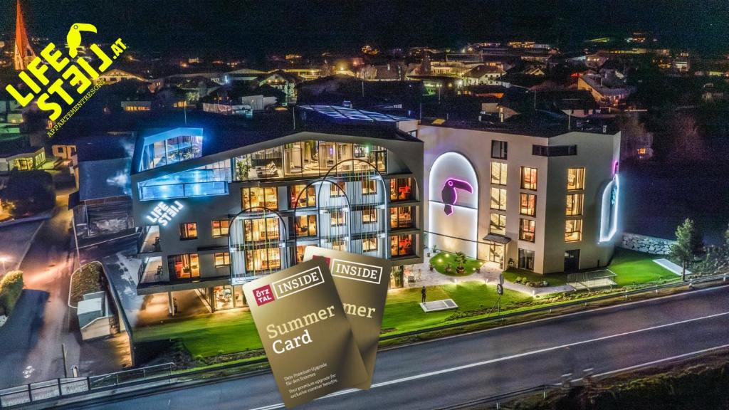 a building with a sign in front of it at night at Lifesteil Aparthotel in Umhausen